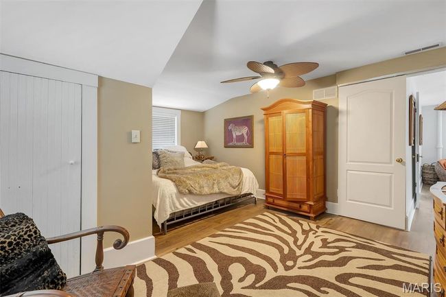 Bedroom featuring light wood-style floors and ceiling fan | Image 72