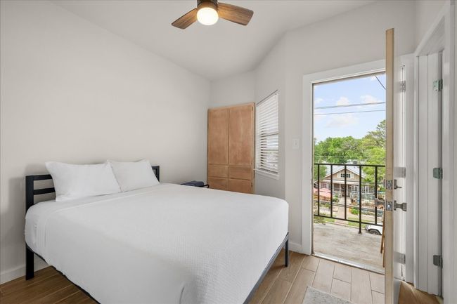 Bedroom featuring access to exterior, wood finished floors, and a ceiling fan | Image 18