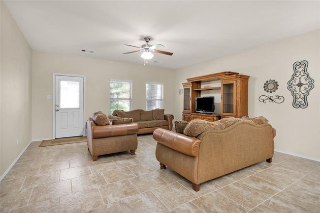 Family room with access to the backyard and covered patio. | Image 22