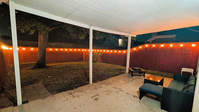 Patio at twilight featuring an outdoor fire pit, a patio area, and a fenced backyard | Image 19