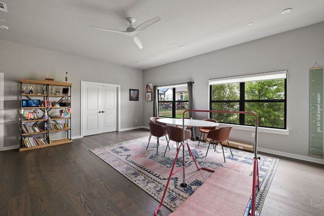 Office space featuring visible vents, baseboards, a ceiling fan, and wood finished floors | Image 29