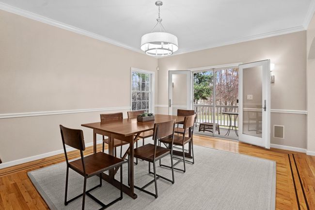 French doors open from the sophisticated dining room to the wraparound porch, blending indoor charm with outdoor ambiance. | Image 17