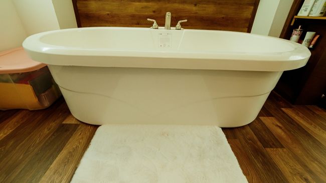 Bathroom featuring a freestanding bath and wood finished floors | Image 28