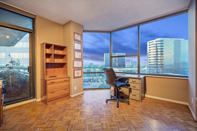 This versatile bedroom can easily double as a home office and offers direct access to the balcony. | Image 17