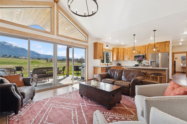 Living area featuring a mountain view, recessed lighting, a notable chandelier, and wood finished floors | Image 24