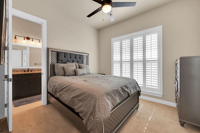 Bedroom featuring light carpet, connected bathroom, and a ceiling fan | Image 21