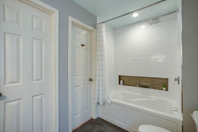 Bathroom with toilet, shower / bath combo, and tile patterned floors | Image 19
