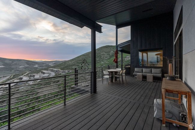 Wooden deck featuring a mountain view and an outdoor living space | Image 85