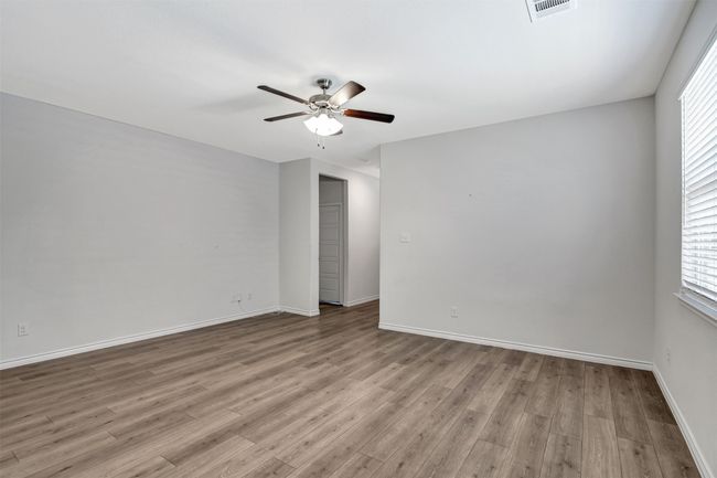 Unfurnished room featuring a ceiling fan and wood finished floors | Image 18