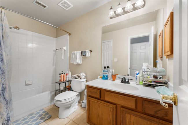 Full bathroom with tile patterned flooring, vanity, toilet, and visible vents | Image 18