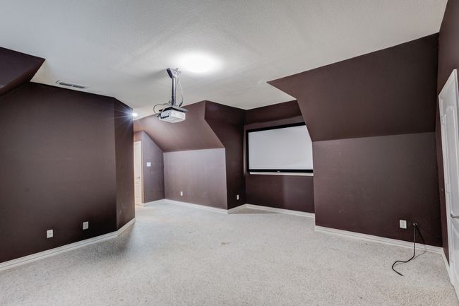 Cinema featuring a textured ceiling | Image 31