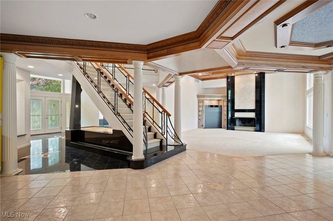 Stairs with decorative columns, crown molding, tile patterned floors, recessed lighting, and french doors | Image 14