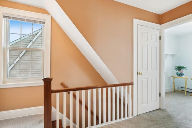 Stairway featuring lofted ceiling and carpet flooring | Image 18