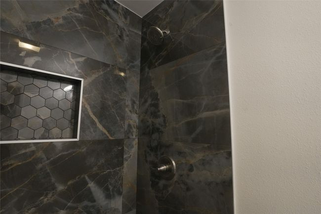 Bathroom view of a marble finish shower | Image 17