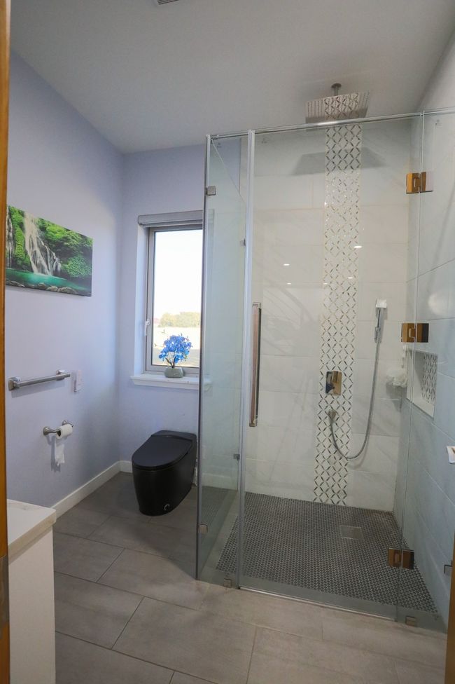 Bathroom with a shower with shower door | Image 6