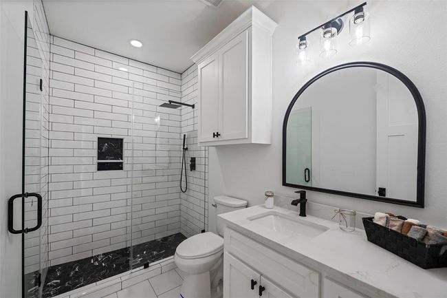 Upstairs third bathroom: sleek design with a modern walk-in shower and elegant fixtures. | Image 35