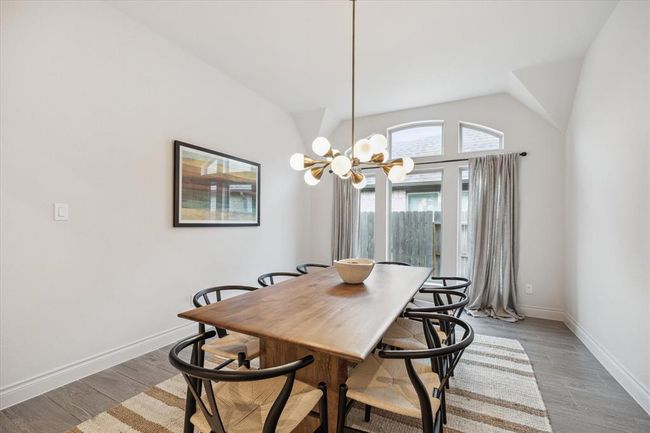 With abundant windows and a custom chandelier, the dining area exudes cheerful elegance, filling every meal with warmth and style. | Image 8