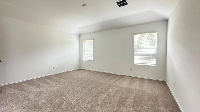 Spare room with visible vents, baseboards, vaulted ceiling, and carpet | Image 7