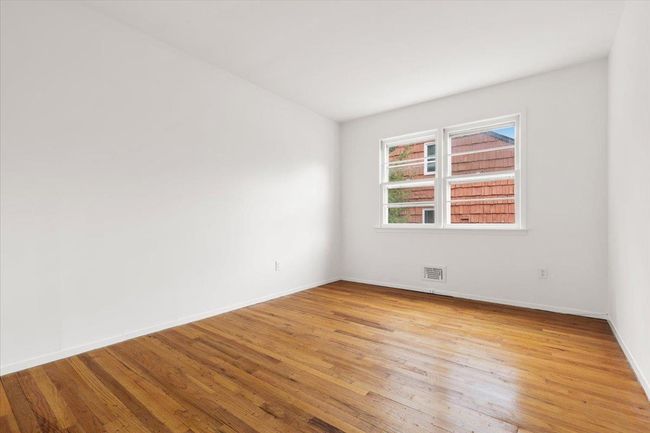 Spare room featuring light wood finished floors, baseboards, and visible vents | Image 20