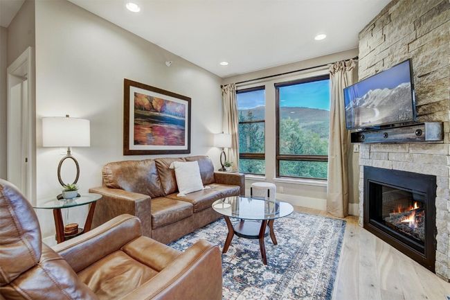 Living area featuring recessed lighting, wood finished floors, and a fireplace | Image 16
