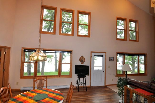 Spacious great room has lots of windows to enjoy big water views. | Image 16