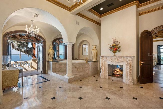 Primary Bathroom with terrace access and double-sided carved marble fireplace. | Image 37