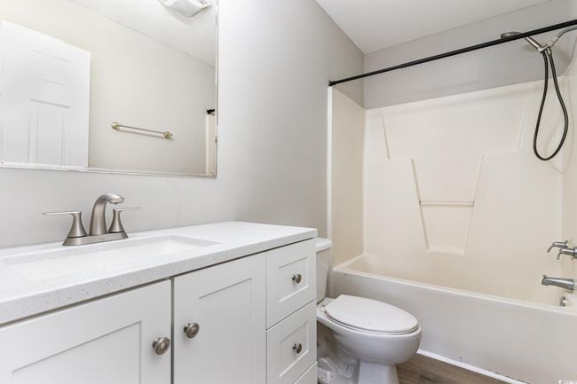 Full bathroom with wood finished floors, vanity, toilet, and shower / bathtub combination | Image 14