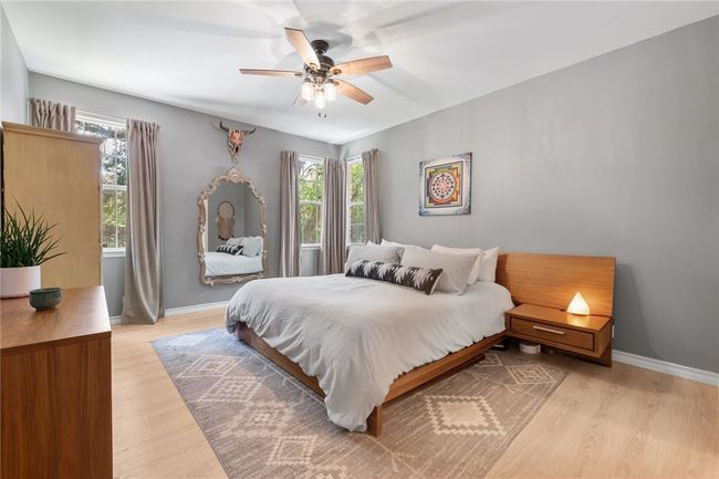 The luxury vinyl plank flooring extends into the primary suite which offers lots of natural light and a large walk-in closet. | Image 14