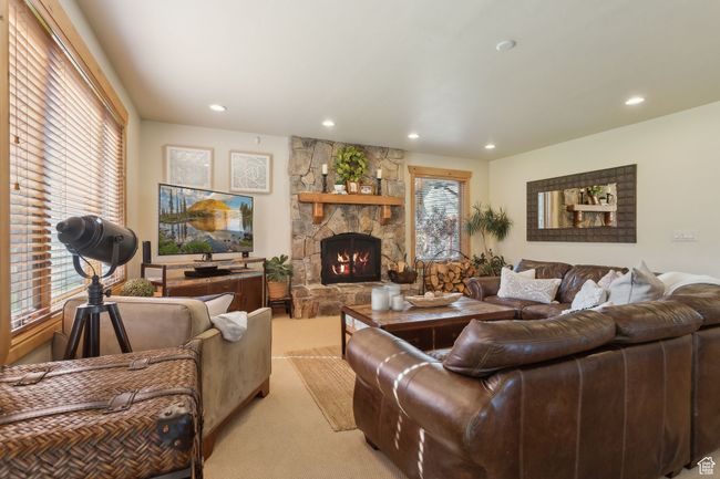 Living area with light colored carpet, a fireplace, plenty of natural light, and recessed lighting | Image 10