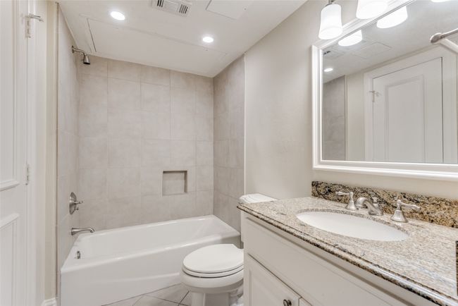 Bathroom with vanity, shower / washtub combination, and tile patterned floors | Image 9