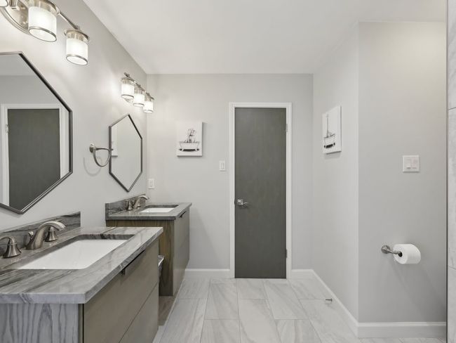 Bathroom featuring a sink, two vanities, and baseboards | Image 25