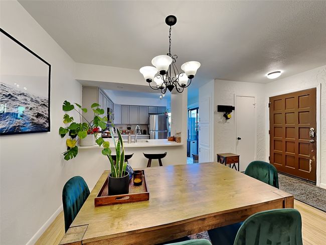 Dining room with a chandelier and light wood-type flooring | Image 6