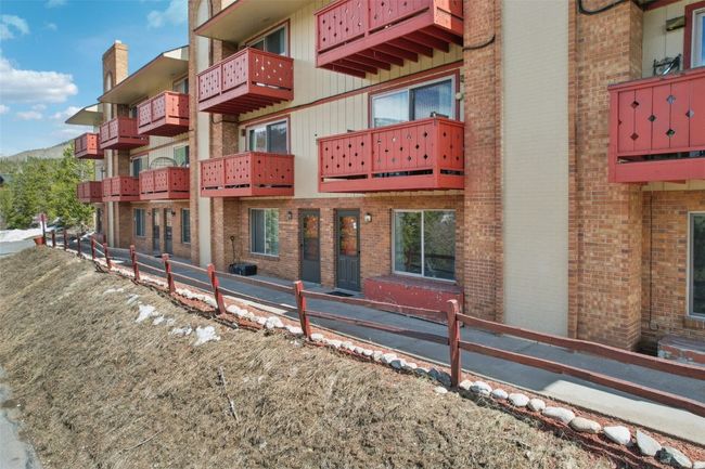 View of building exterior featuring fence | Image 26