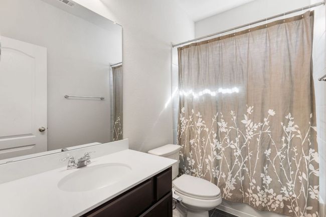 This bathroom is located adjacent to the secondary bedroom on the main/first floor. | Image 18