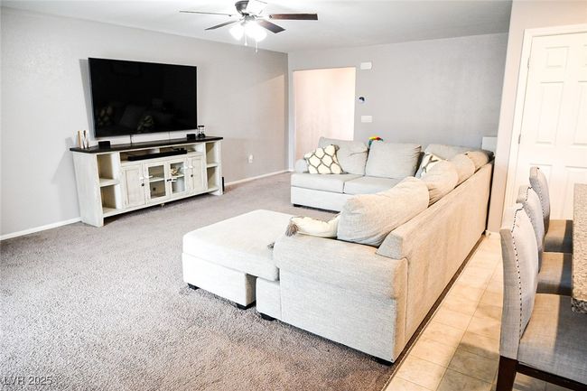 Living room featuring a ceiling fan and baseboards | Image 12