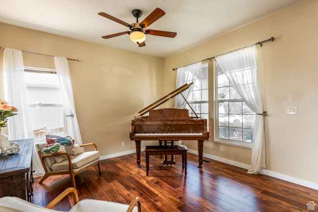 Living area with a ceiling fan, hardwood / wood-style floors, and baseboards | Image 5