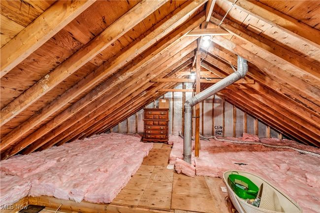 FULLY FLOORED ATTIC STORAGE - ACCESS FROM PRIMARY SUITE WITH WALK UP STAIRCASE | Image 37