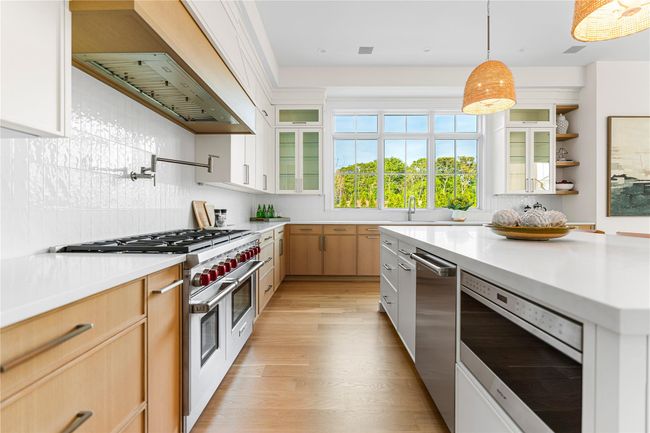 Kitchen with appliances with stainless steel finishes, light countertops, and tasteful backsplash | Image 19