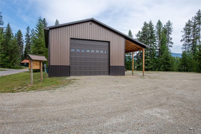 Garage with a garage and driveway | Image 51