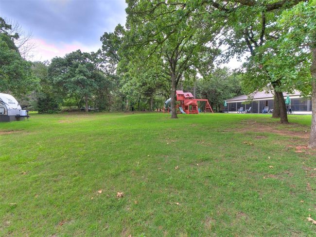 View of grassy yard with a playground | Image 7