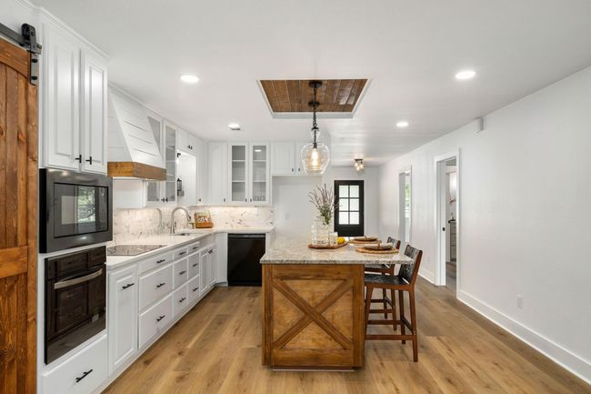 Elegant custom kitchen featuring modern appliances, sleek cabinetry, and a stylish island perfect for entertaining. | Image 11