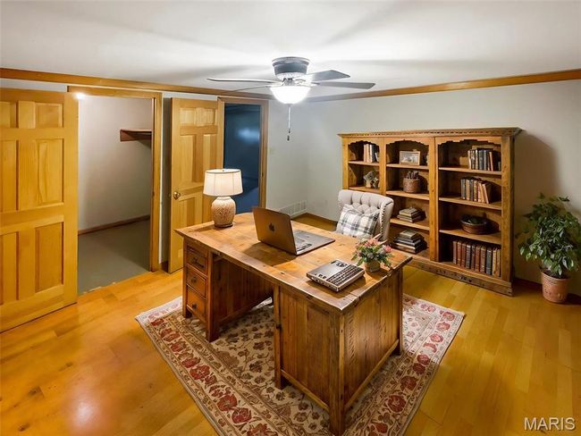 Office with a ceiling fan and light wood-style flooring | Image 15