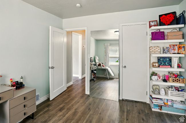 Bedroom with dark wood-type flooring | Image 12