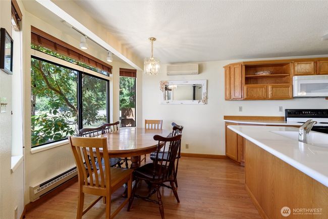 Your kitchen has a view of the water with large windows and plenty of sunlight. | Image 12