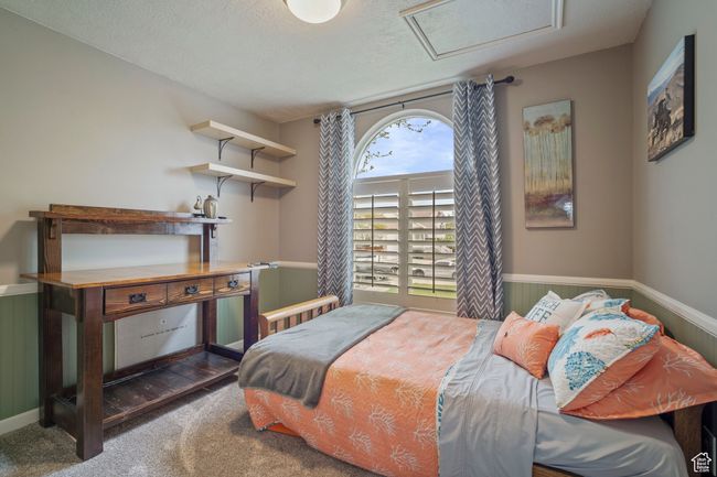 Carpeted bedroom with attic access and wainscoting | Image 14