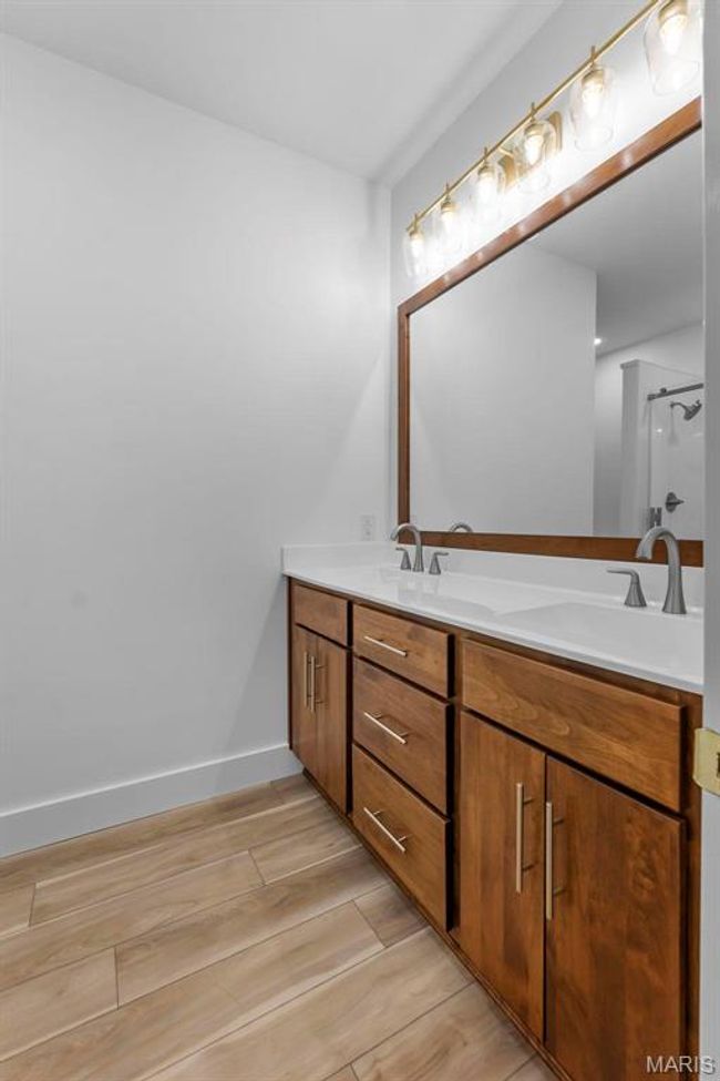 Bathroom featuring a shower and vanity | Image 12