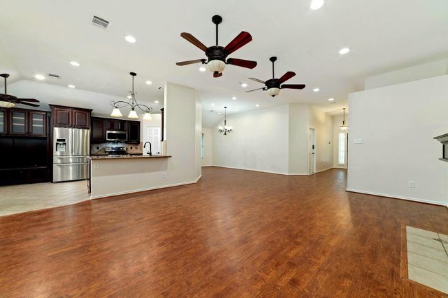 Perfect for gatherings and holiday celebrations, this kitchen invites you to become the host of the night. Seamlessly connected to the breakfast area, bar, family room, and dining room, it offers an ideal flow for effortless entertaining and memorable moments. | Image 16