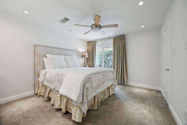 Second primary bedroom with closet and balcony overlooking front greenspace | Image 21