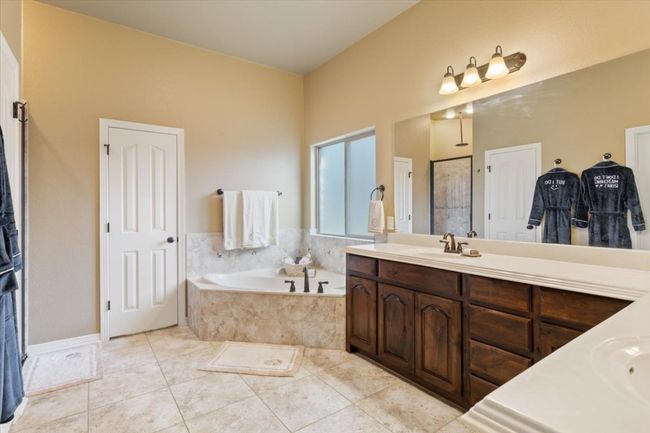Full bath with a bath, tile patterned floors, a walk in shower, and vanity | Image 23