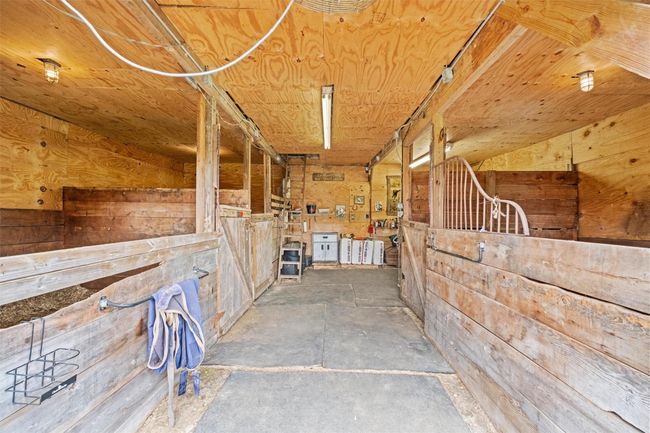 Interior view of barn features 3 stalls and bonus space for grooming, tack, feed or storage | Image 27